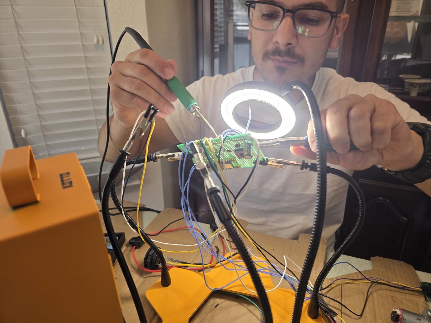 Jimmy Grozav soldering the prototype circuit board for his automated dog feeder